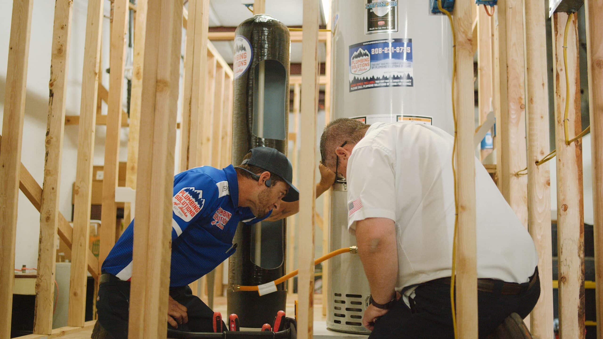 Plumbing solutions of Idaho employee installing a water heater installation inside in Boise, ID