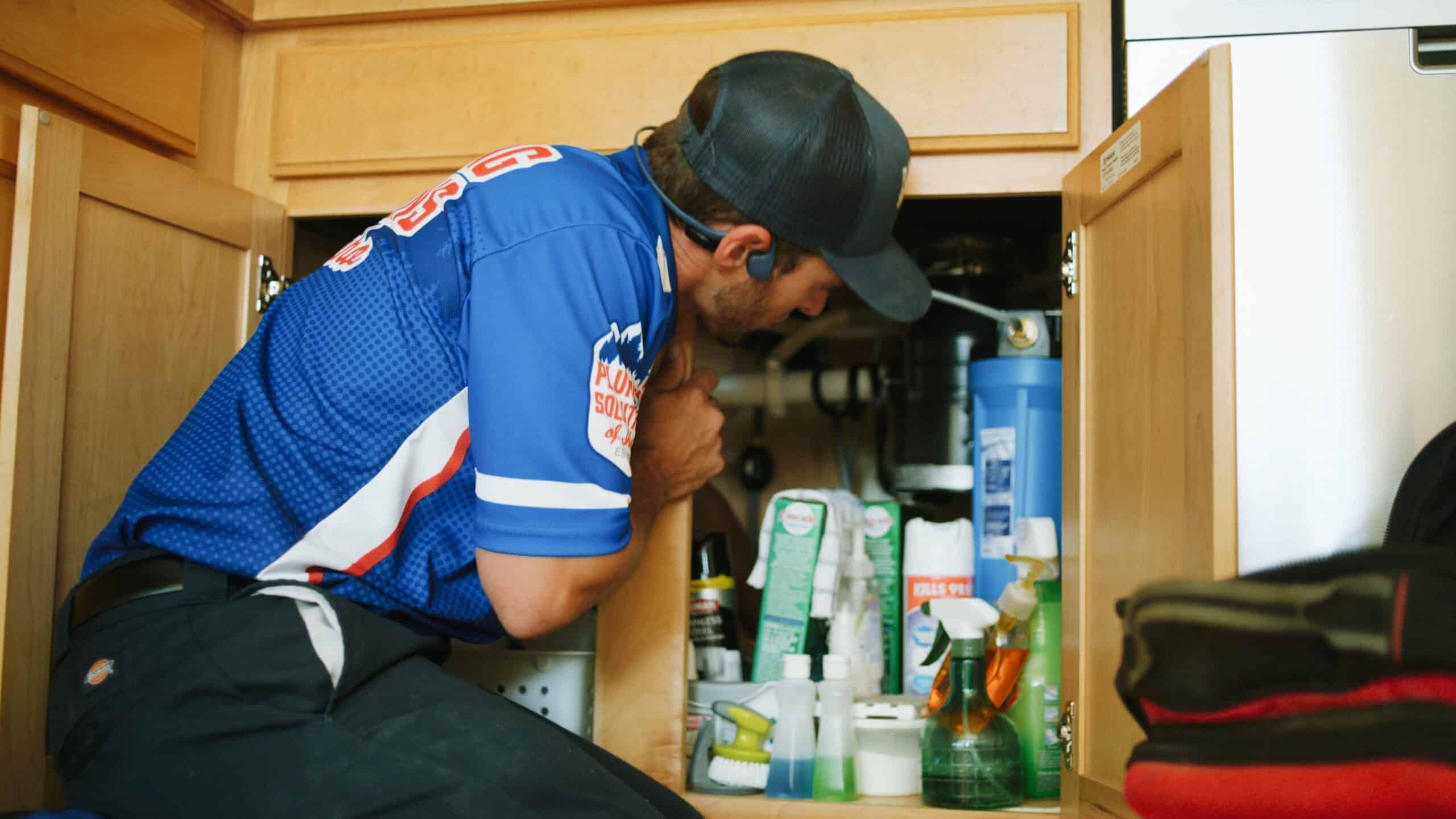 Plumber fixing sink in the kitchen in Boise, ID