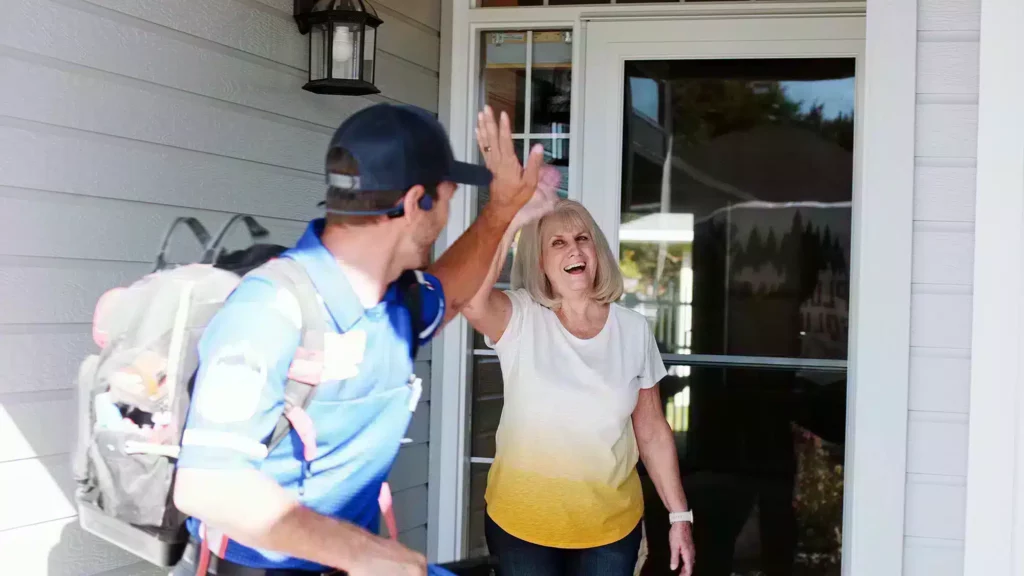 Customer and Plumbing Solutions of Idaho employee waving goodbye after service